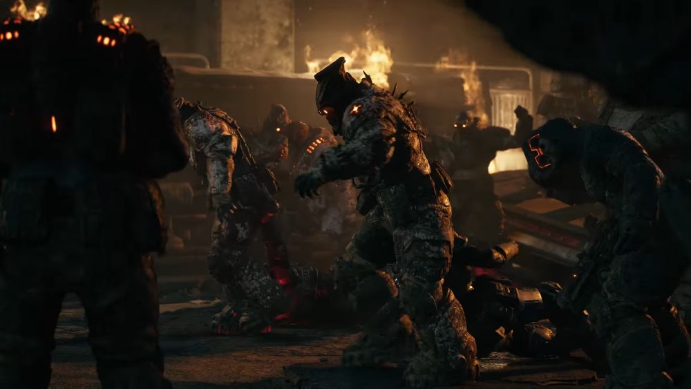 Grupa Locusta napada vojnike u mračnom i razorenom prostoru u igri Gears of War: E-Day.